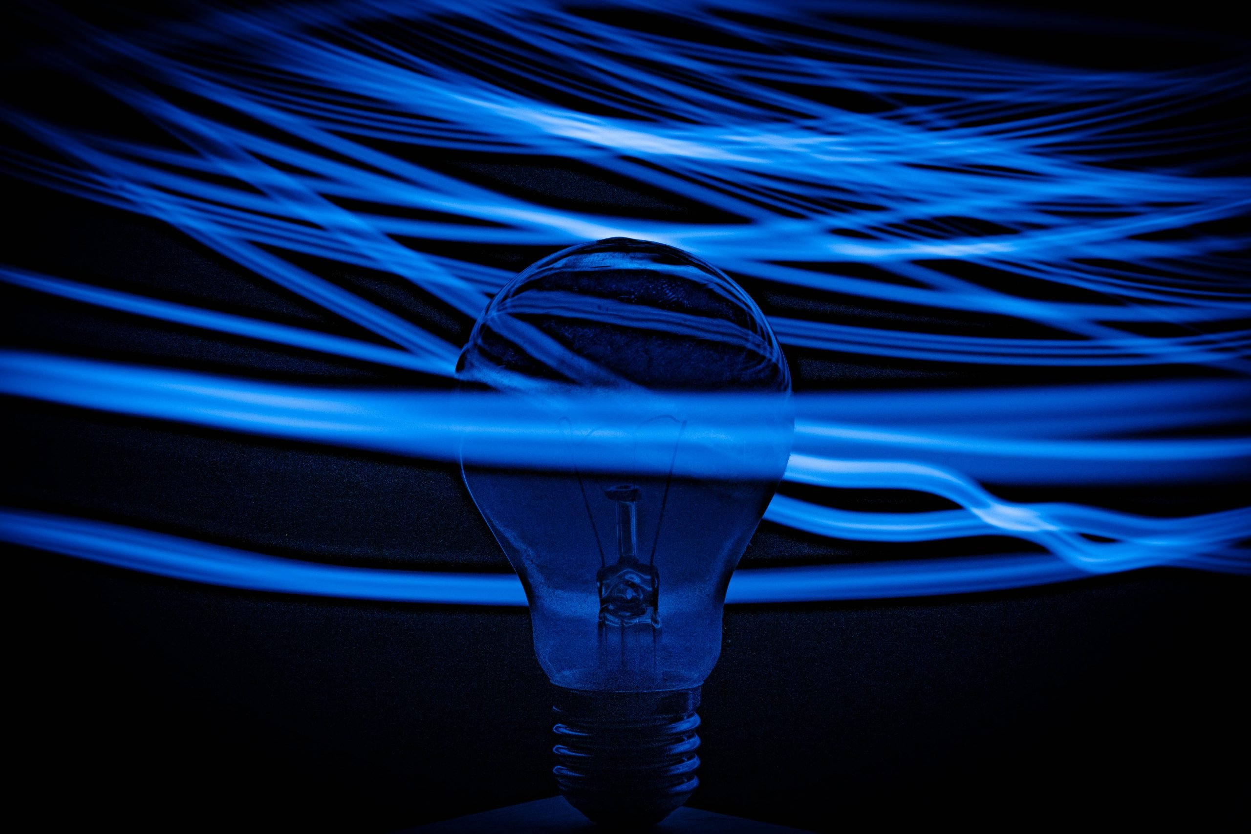 Lightbulb surrounded by glue streaks of light