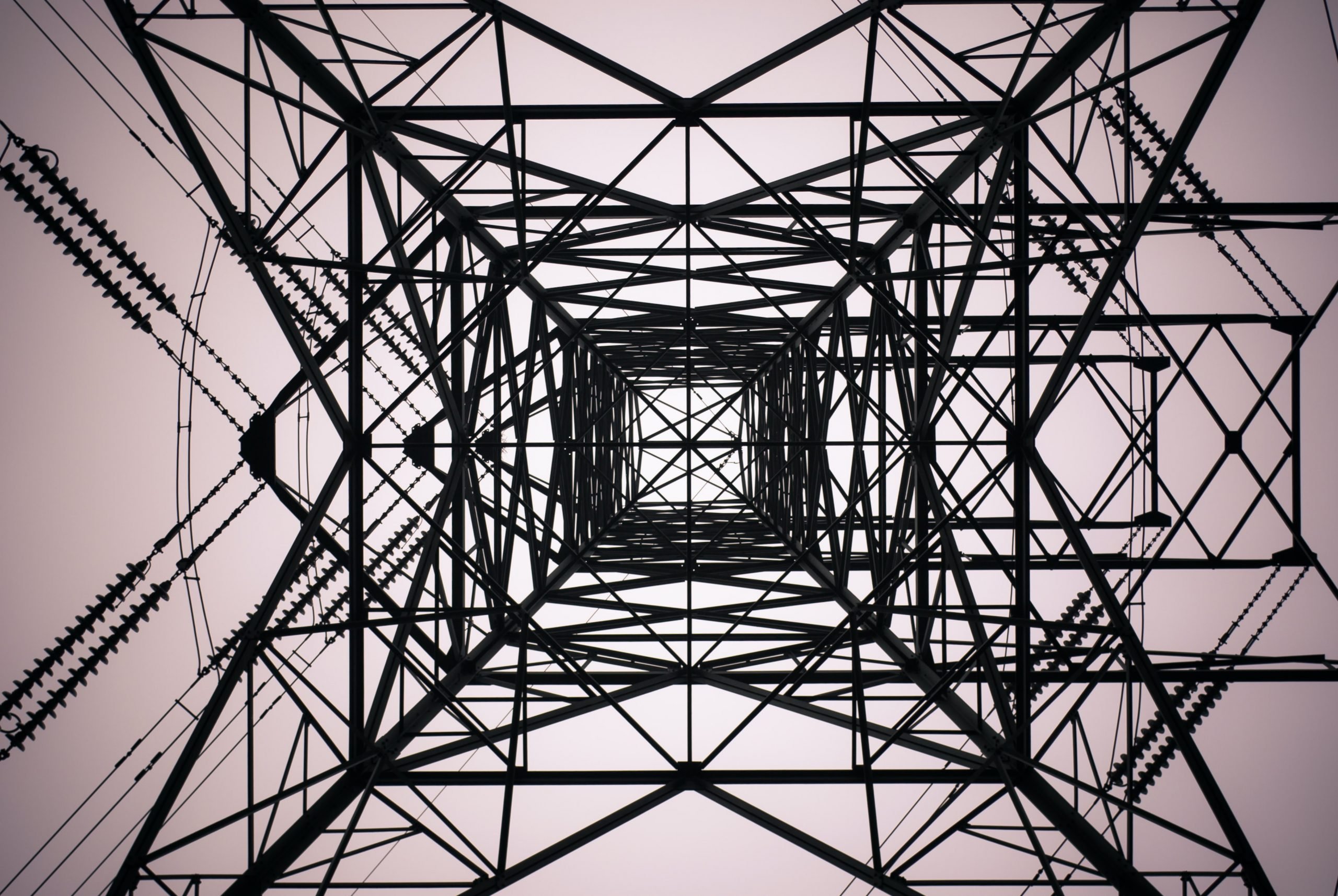 Ground to sky perspective of a black electrical tower