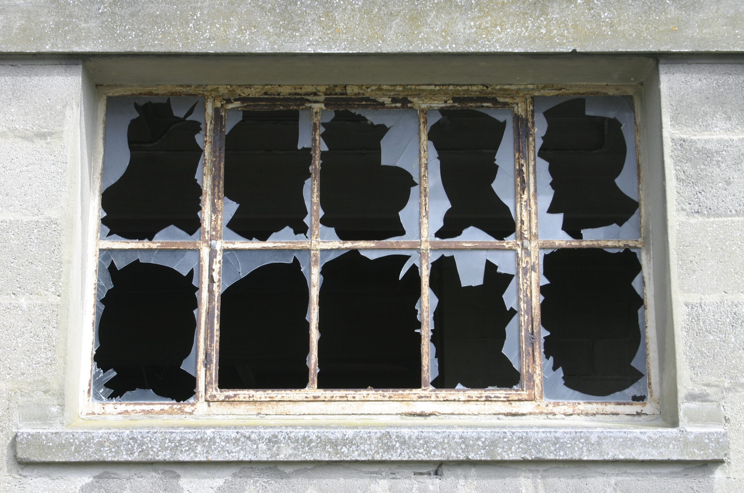 Broken windows on cement building