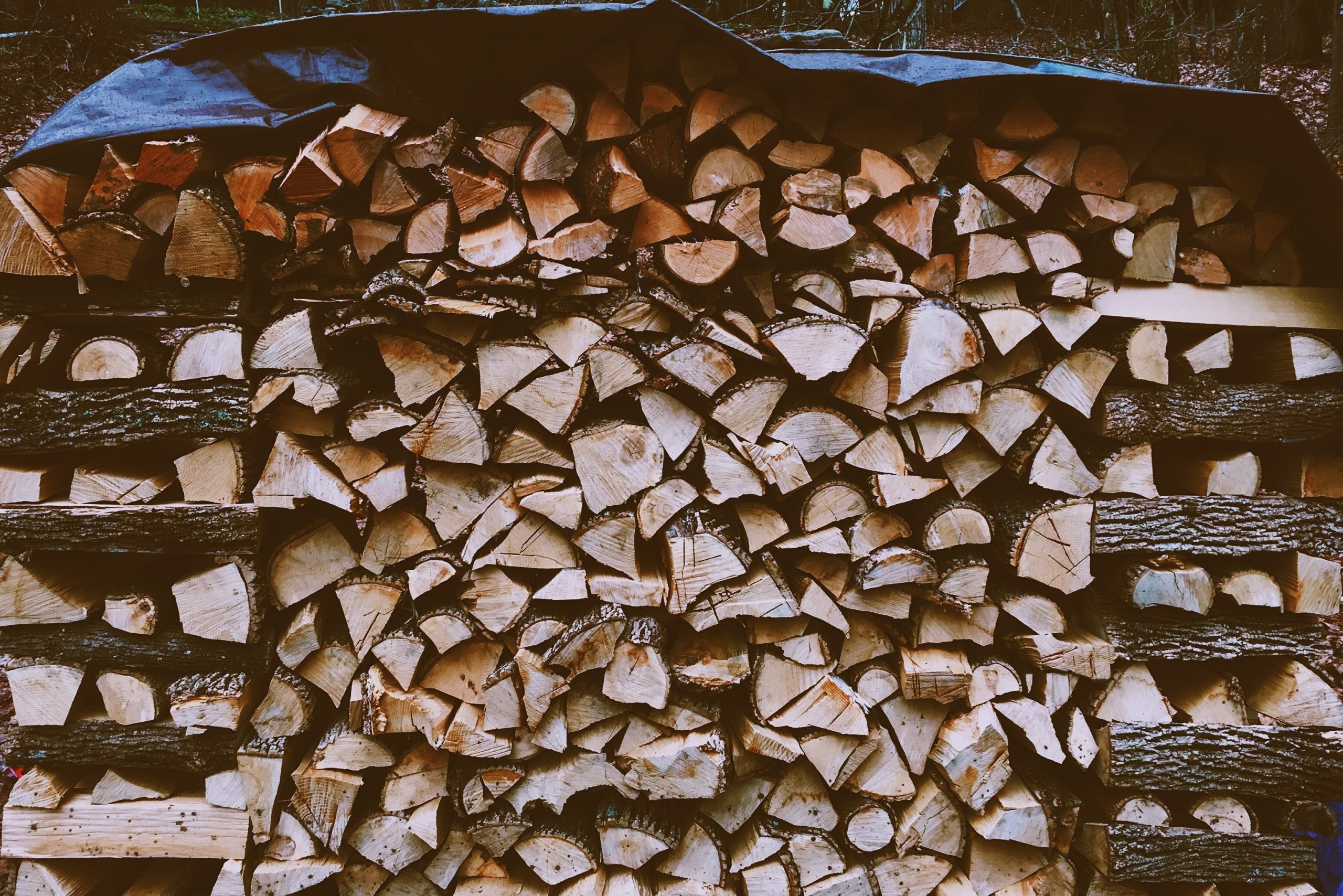 Photo of Stacked Chopped Wood by Jon Tyson on Unsplash for Productivity vs Focus blog