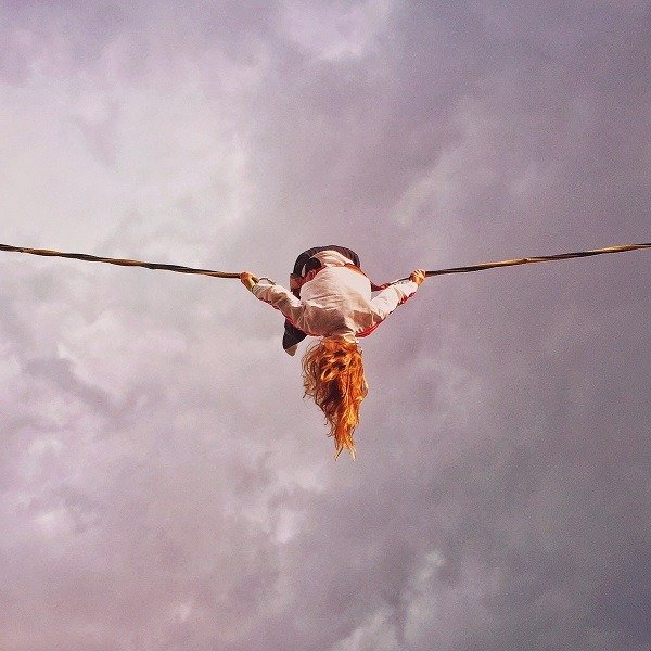 Woman Hanging Upside Down From Wires